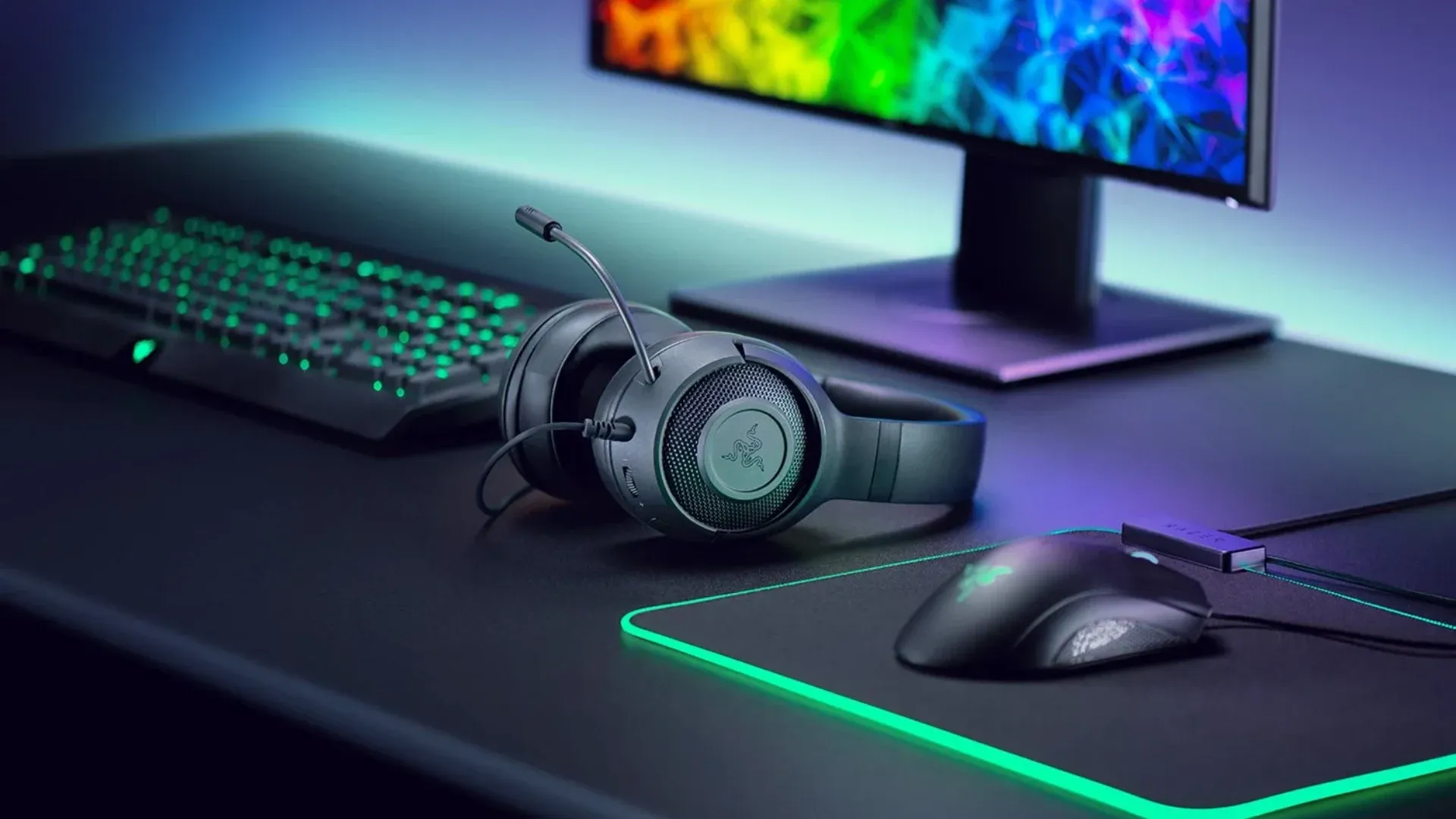 A imagem apresenta o headset Razer Kraken X Lite disposto em uma mesa com outros periféricos da Razer.