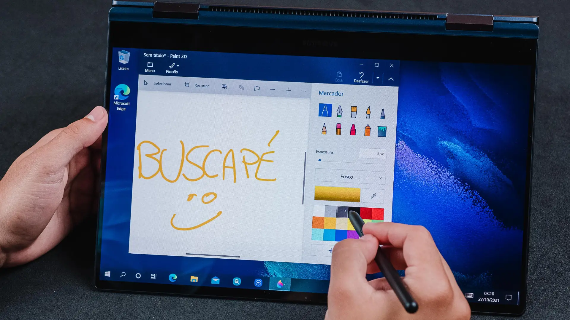 Imagem da tela de um notebook Samsung Galaxy Book Pro 360 com a palavra "Buscapé" escrita em amarelo na tela com a caneta S Pen