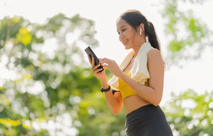 Mulher se exercitando com o smartphone com acelerômetro no celular