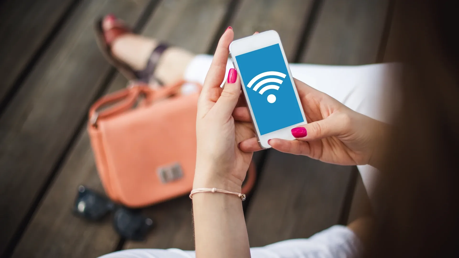 Mulher segurando celular conectado na internet via Wi-Fi nas mãos