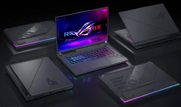Imagem do notebook Asus ROG Strix G16 com um notebook aberto no centro cercado por quatro fechados ao redor 