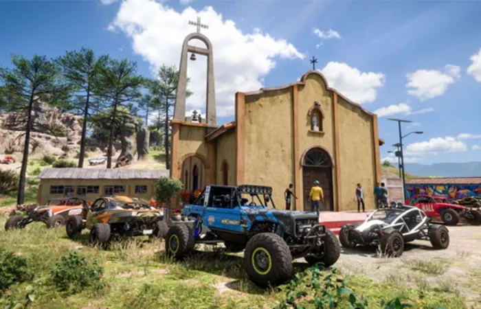 Imagem do jogo Forza Horizon 5 com vários carros off-road em frente a uma igreja como um jipe azul e buggys branco e vermelho