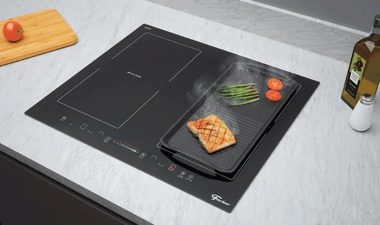Cooktop por indução da Fischer ligado com alguns alimentos sendo preparados.
