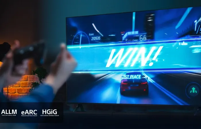 Pessoa jogando videogame com "WIN!" exibido na tela da TV LG UT9050