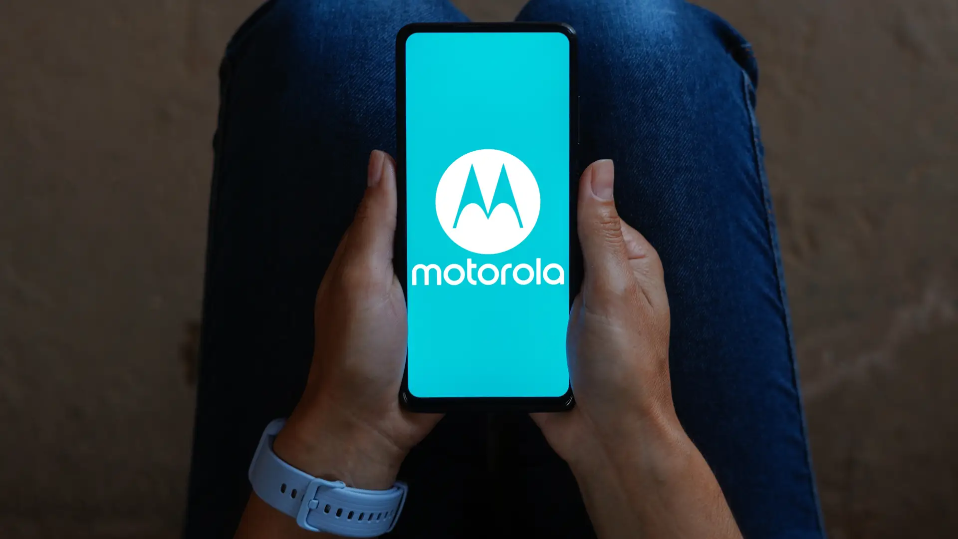 Um celular está com a tela ligada. Na tela aparece escrito Motorola