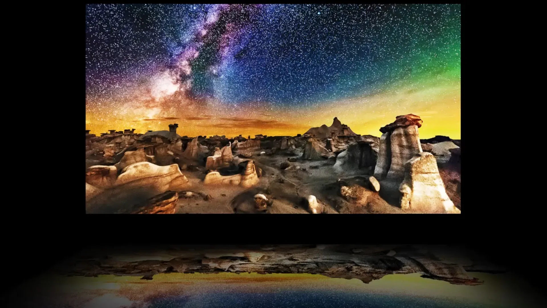 Imagem da LG OLED C3 mostrando paisagem noturna com céu estrelado e reflexo colorido no painel OLED evo 4K.