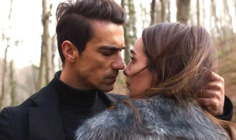 divulgação da série turca Asas da Ambição, com um casal se encarando de perto em um cenário de floresta.