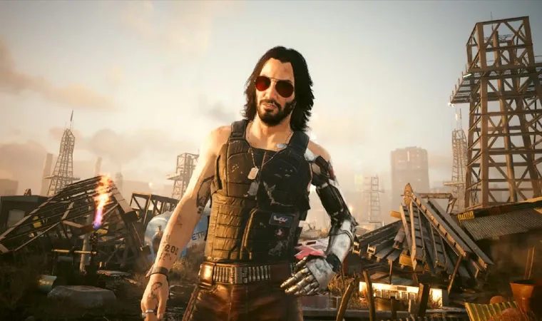 Imagem do jogo Cyberpunk 2077: Ultimate Edition no Nintendo Switch 2 exibindo o personagem Johnny Silverhand, interpretado pelo ator Keanu Reeves, em um ferro-velho