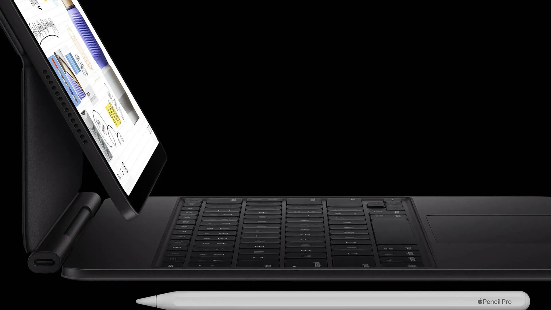 Imagem do iPad Pro M5 conectado ao Magic Keyboard, com Apple Pencil Pro apoiado abaixo.