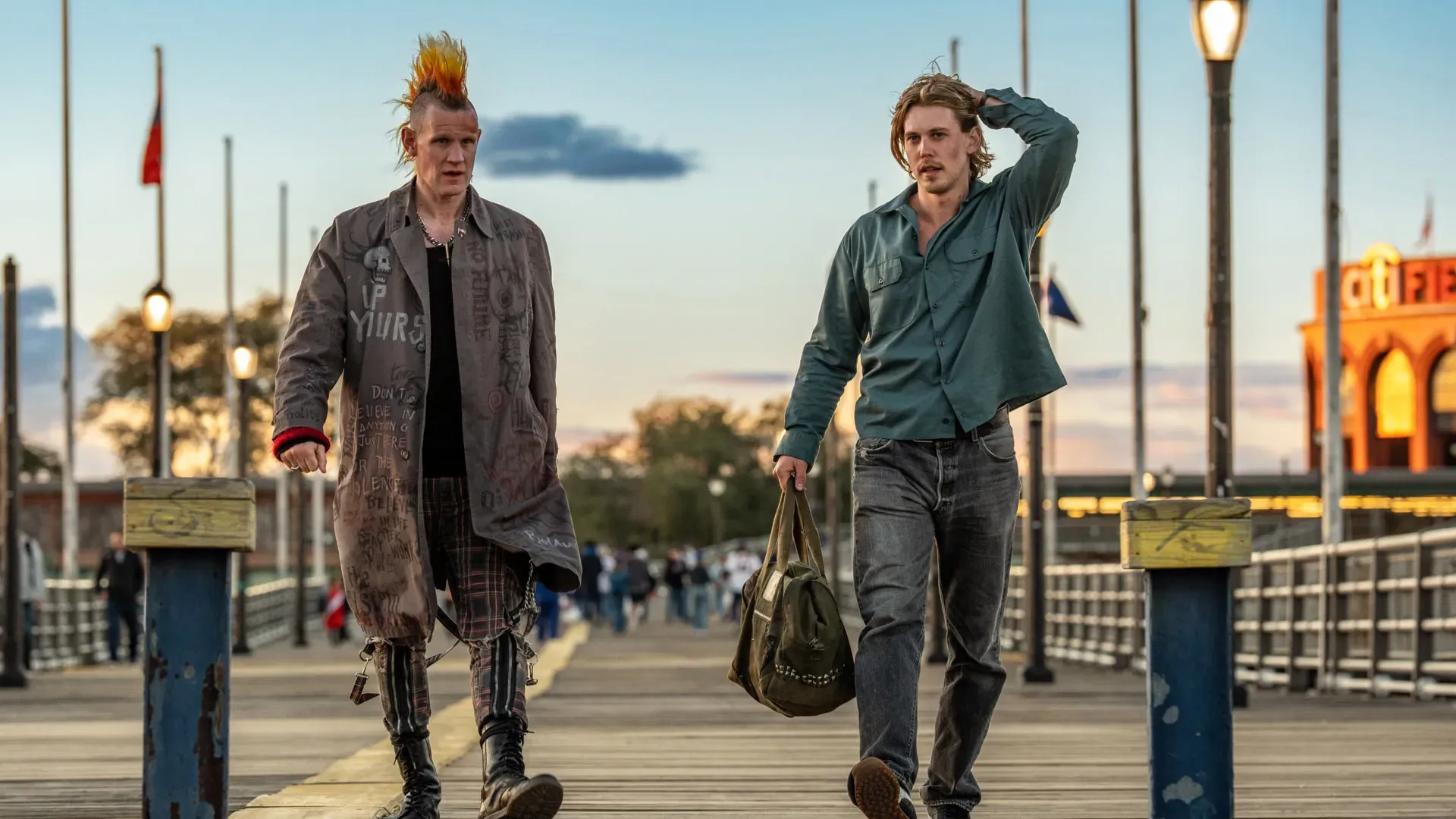 Imagem de dois homens caminhando em píer com luz do entardecer no filme Ladrões